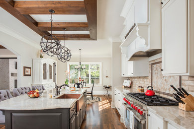 Design ideas for an eat-in kitchen in Charlotte with a farmhouse sink, quartzite benchtops, stainless steel appliances and medium hardwood floors.