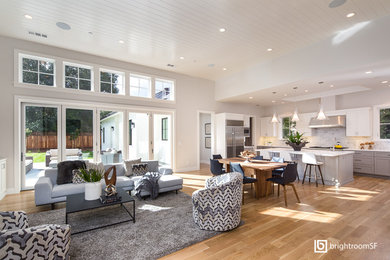 Design ideas for a large transitional open concept living room in San Francisco with white walls and light hardwood floors.