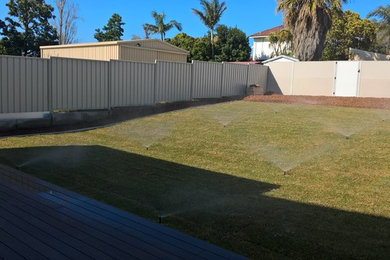 Photo of a large contemporary backyard garden for summer in Perth.