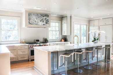 Example of a large transitional l-shaped light wood floor and gray floor open concept kitchen design in Birmingham with an undermount sink, flat-panel cabinets, gray cabinets, marble countertops, stainless steel appliances, an island and gray countertops