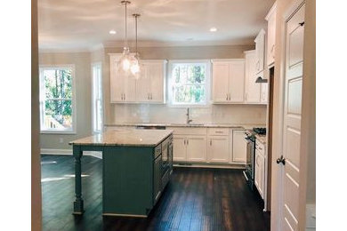 Example of a farmhouse kitchen design in Raleigh with an undermount sink, shaker cabinets, white cabinets, granite countertops and white countertops