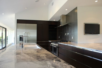 Large contemporary l-shaped separate kitchen in Los Angeles with an undermount sink, black splashback, ceramic splashback, stainless steel appliances, ceramic floors, beige floor, flat-panel cabinets, dark wood cabinets, granite benchtops and with island.