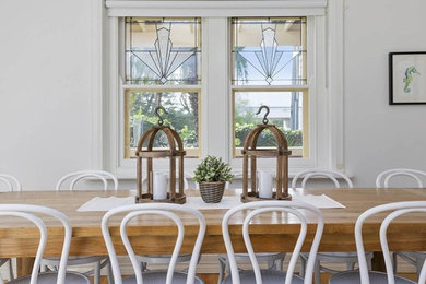 This is an example of a transitional dining room in Melbourne.