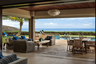 Patio - large tropical backyard stamped concrete patio idea in Hawaii
