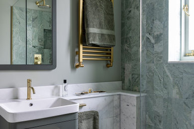 Design ideas for a medium sized contemporary ensuite half tiled bathroom in London with green cabinets, a walk-in shower, a wall mounted toilet, green tiles, marble tiles, green walls, marble flooring, an integrated sink, marble worktops, white floors, an open shower, white worktops, a wall niche, a single sink, a floating vanity unit and a vaulted ceiling.