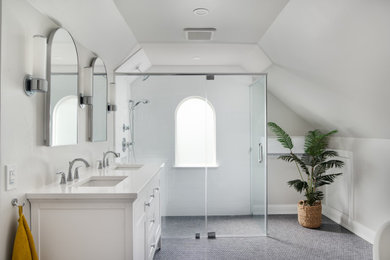 Example of a mid-sized transitional master white tile and ceramic tile ceramic tile, blue floor, double-sink and vaulted ceiling bathroom design in Baltimore with shaker cabinets, white cabinets, a two-piece toilet, gray walls, an undermount sink, quartz countertops, a hinged shower door, white countertops, a niche and a freestanding vanity