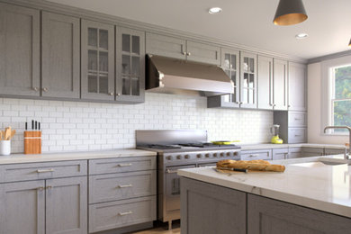 Open concept kitchen - mid-sized transitional l-shaped medium tone wood floor and brown floor open concept kitchen idea in Orlando with an undermount sink, recessed-panel cabinets, gray cabinets, marble countertops, white backsplash, subway tile backsplash, stainless steel appliances, an island and white countertops