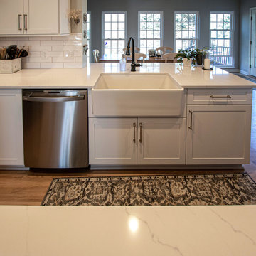 Siteline White Kitchen with Gray Island and Calacatta Miraggio Quartz Countertop