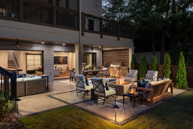 Mid-sized transitional backyard concrete patio photo in Atlanta with a fire pit and a roof extension
