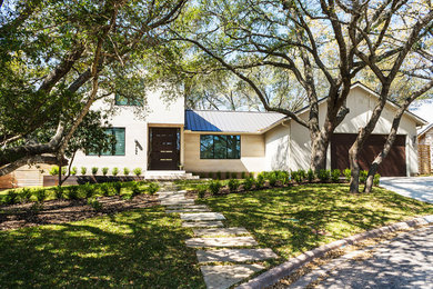 Transitional beige two-story exterior home photo in Austin