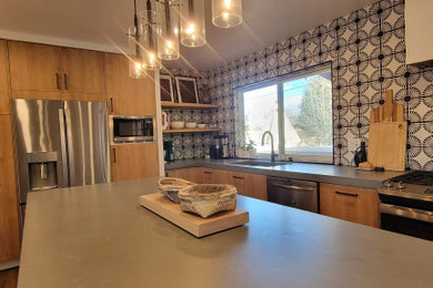 Eat-in kitchen - mid-sized cottage l-shaped vinyl floor and brown floor eat-in kitchen idea in Albuquerque with a single-bowl sink, flat-panel cabinets, medium tone wood cabinets, quartzite countertops, multicolored backsplash, cement tile backsplash, stainless steel appliances, an island and gray countertops