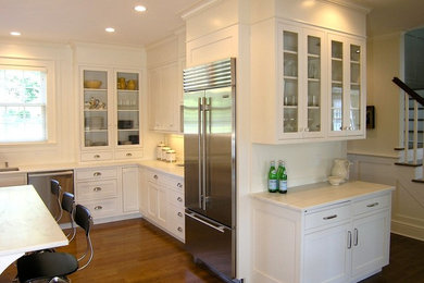 Inspiration for a cottage u-shaped eat-in kitchen remodel in New York with an undermount sink, recessed-panel cabinets, marble countertops, white backsplash and stainless steel appliances