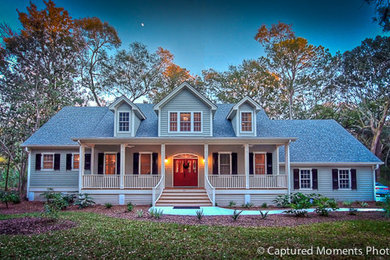 Mid-sized elegant green two-story vinyl gable roof photo in Charleston