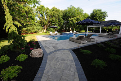 Large elegant backyard stone and rectangular lap hot tub photo in Philadelphia