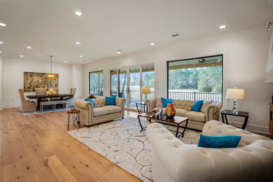 Example of a large transitional open concept medium tone wood floor and brown floor family room design in Houston
