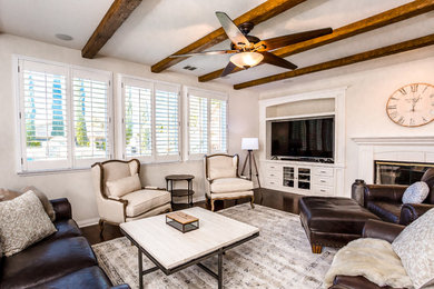 Example of a large transitional open concept living room design in San Diego with a media wall