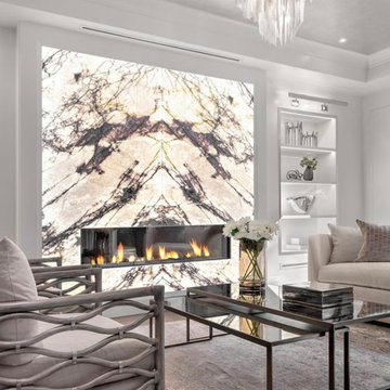 Living Room Luxury: Backlit Bookmatched Marble Fireplace