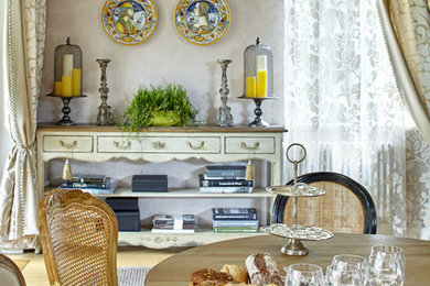 Inspiration for an eclectic dining room in Moscow with beige walls and light hardwood floors.