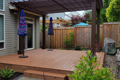 Inspiration for a mid-sized traditional partial sun backyard wood fence garden path in Portland with decking for summer.