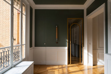 Foyer in Paris with green walls and light hardwood floors.