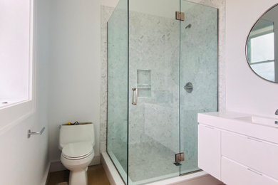 Example of a master corner shower design with a hinged shower door