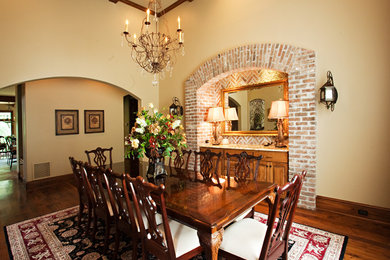Large traditional separate dining room in New Orleans with beige walls, dark hardwood floors and no fireplace.