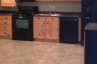 Basement - craftsman porcelain tile and beige floor basement idea in Other with beige walls