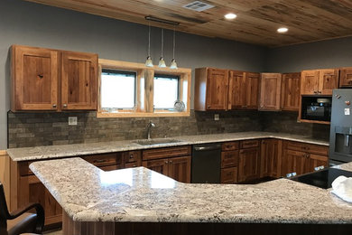 Inspiration for a mid-sized country l-shaped kitchen in Wichita with granite benchtops, grey splashback, porcelain splashback, vinyl floors and with island.