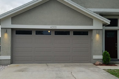 This is an example of a medium sized contemporary attached double garage in Orlando.