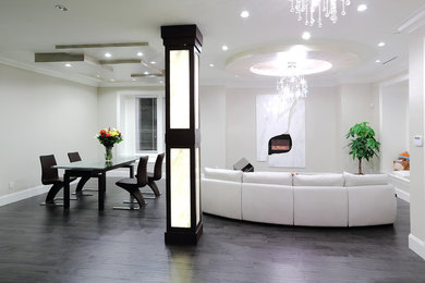 Inspiration for a large modern open concept dark wood floor living room remodel in Vancouver with gray walls, a stone fireplace, a standard fireplace and no tv