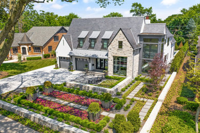 Example of a large transitional white two-story stucco exterior home design in Chicago with a tile roof