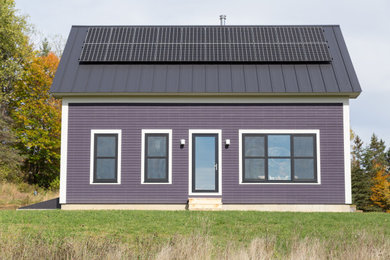 Example of a trendy brown two-story wood exterior home design with a metal roof