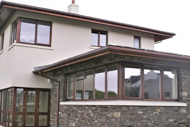 Photo of an exterior in Cork with a hip roof and a metal roof.