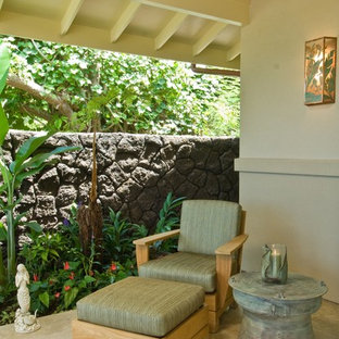 Design ideas for a tropical patio in Hawaii with a roof extension.