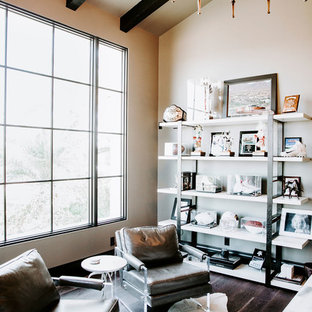Photo of a large modern study in Phoenix with grey walls, dark hardwood flooring, a freestanding desk and black floors.