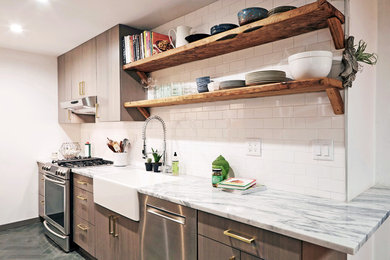 Photo of a small country galley separate kitchen in New York with a farmhouse sink, flat-panel cabinets, grey cabinets, quartzite benchtops, white splashback, subway tile splashback, stainless steel appliances, slate floors and no island.