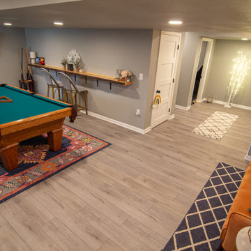 Basement Utilizing Open Space to Shoot Pool and Watch Favorite Sports Team