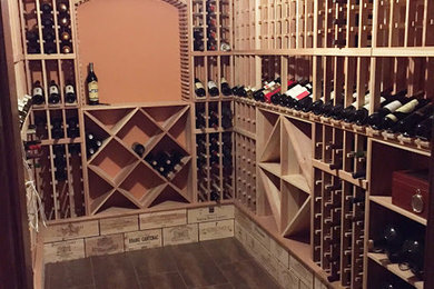 Wine cellar - mid-sized transitional wine cellar idea in New York