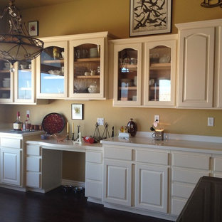 Large traditional kitchen pantry remodeling - Example of a large classic l-shaped medium tone wood floor kitchen pantry design in Las Vegas with raised-panel cabinets, white cabinets, granite countertops, yellow backsplash, stainless steel appliances and an island