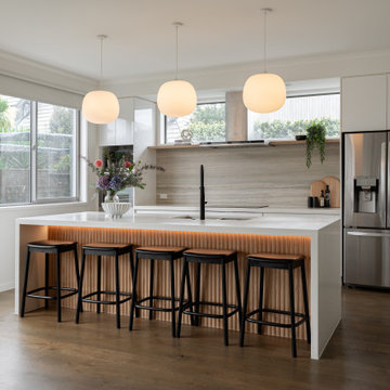 Modern kitchen renovation with timber detailing and soft lighting