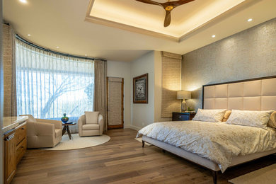 Inspiration for a large transitional master medium tone wood floor, brown floor, vaulted ceiling and wallpaper bedroom remodel in Phoenix