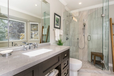 Inspiration for a mid-sized traditional master bathroom in Vancouver with shaker cabinets, a freestanding tub, an undermount sink, a one-piece toilet, grey walls, porcelain floors and grey floor.