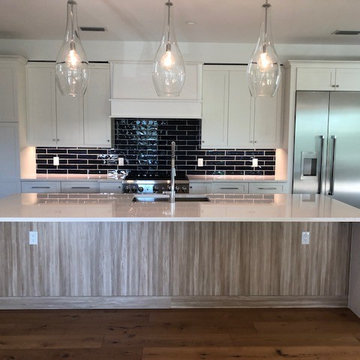Kitchen with White Quartz Counter and Waterfall Legs