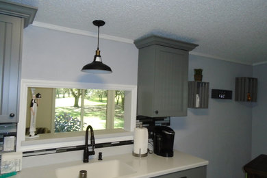 Beautiful gray painted beadboard cabinets with solid surface countertops