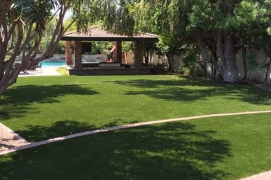 Example of a mid-sized island style backyard rectangular lap pool house design in Phoenix