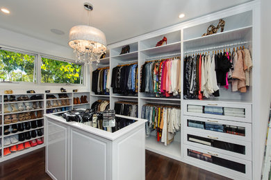 Inspiration for a large contemporary women's walk-in wardrobe in Sydney with open cabinets, white cabinets and light hardwood floors.