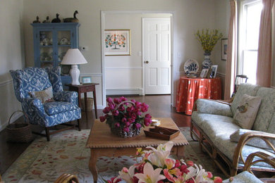 Inspiration for a mid-sized coastal enclosed and formal medium tone wood floor living room remodel in New York with white walls, no tv and no fireplace