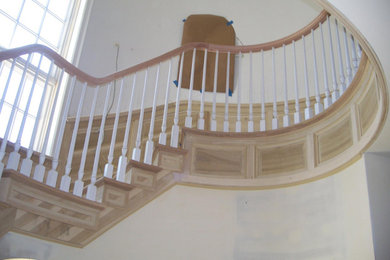 Staircase - large coastal wooden curved wood railing staircase idea in Chicago with wooden risers