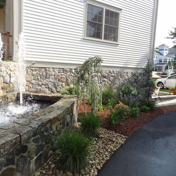 Cape Cod Inn with New England Stone Cladding, Retaining Walls, and Water Feature