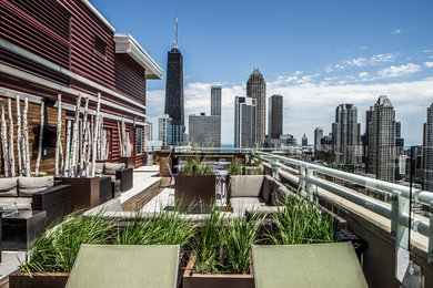 Inspiration for a large contemporary rooftop deck remodel in Chicago with a fire pit and no cover